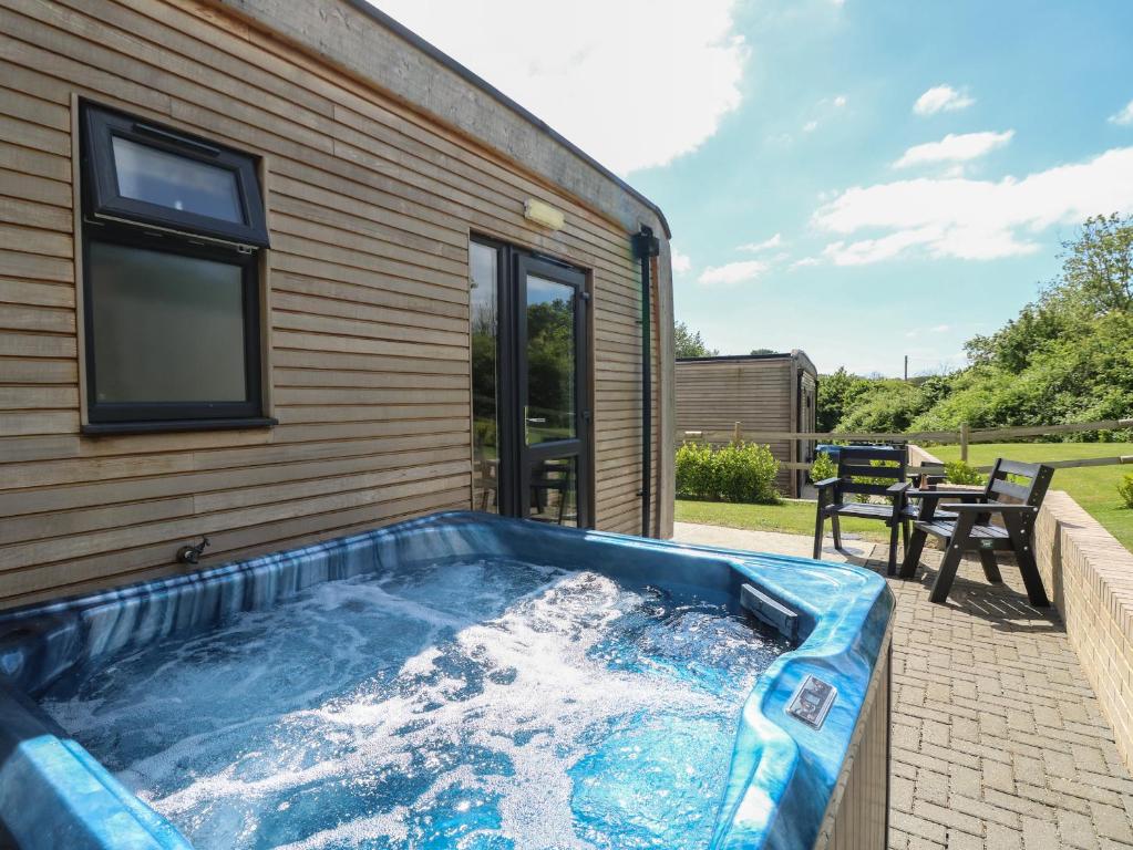 a hot tub on the side of a house at Cava in Ryde