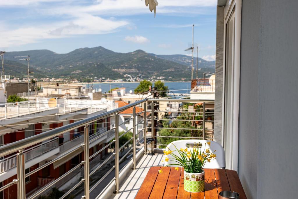 a balcony with a table and a view of the water at Teo Apartment in Iraklitsa