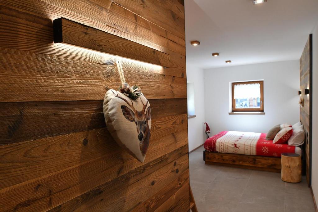 a room with a wooden wall with a head on it at Chalet Ginepro - Chalet Maso Vecchio con vista montagne Passo Brocon, Trentino in Castello Tesino