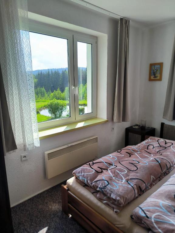 Postel nebo postele na pokoji v ubytování Chata Rybná 18