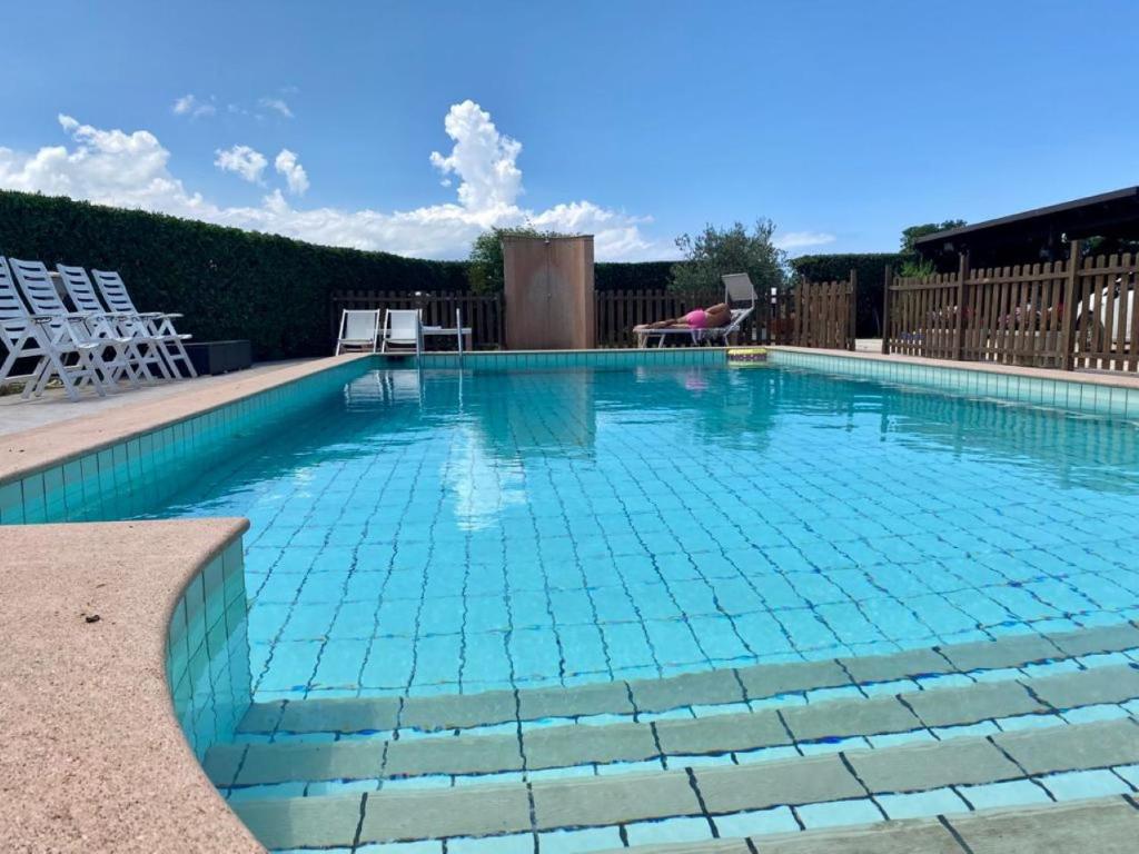 a swimming pool with blue tiles on the water at casa Maruzza in Casteldaccia