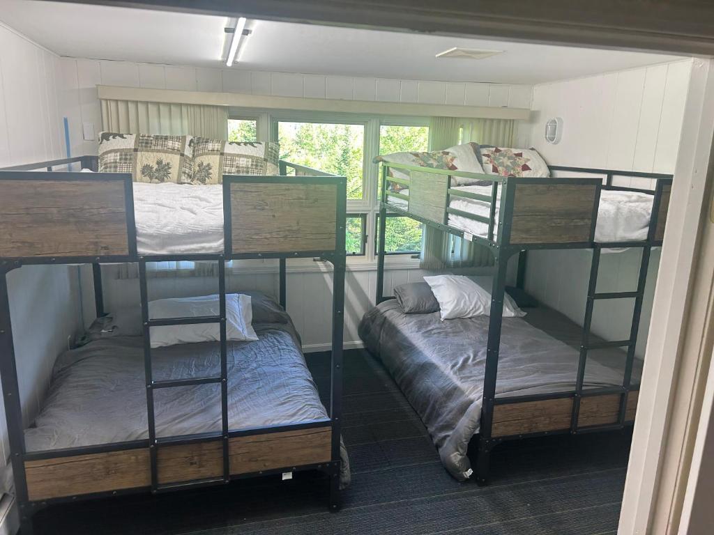 a room with three bunk beds and a window at Spacious Mountainside Home In Jackson Incredible Views, Hot Tub, Pet Friendly in Jackson