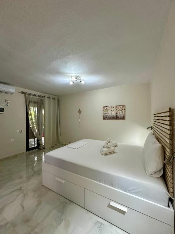 Postel nebo postele na pokoji v ubytování Hotel Argilos