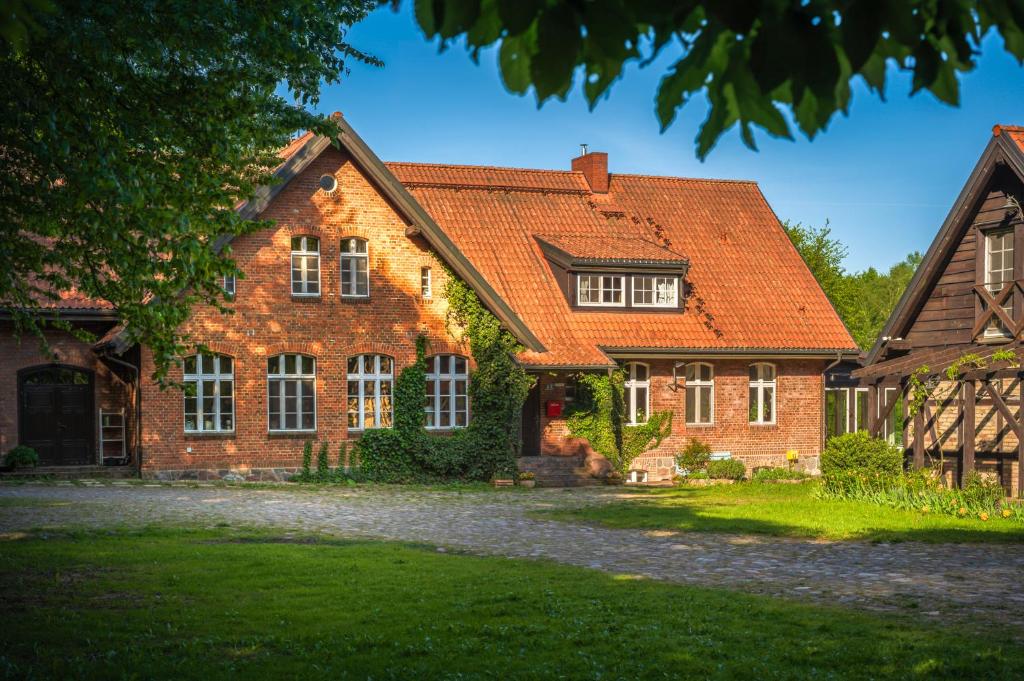 a brick house with an orange roof at Dom Gościnny Stara Szkoła in Wysoka Wieś
