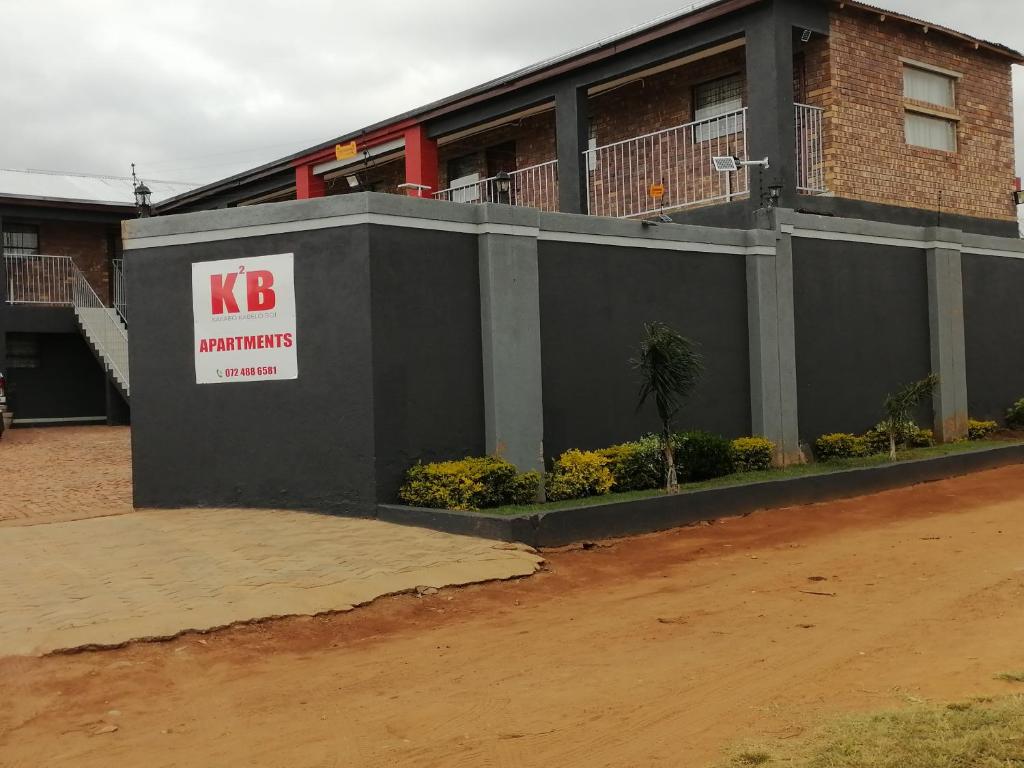 a building with a sign on the side of it at Karaboapartlodge in Jane Furse
