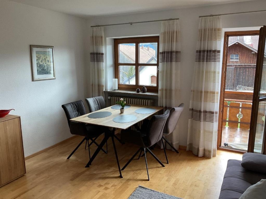 a dining room table and chairs in a living room at Gästehaus Sonnenberg in Bolsterlang