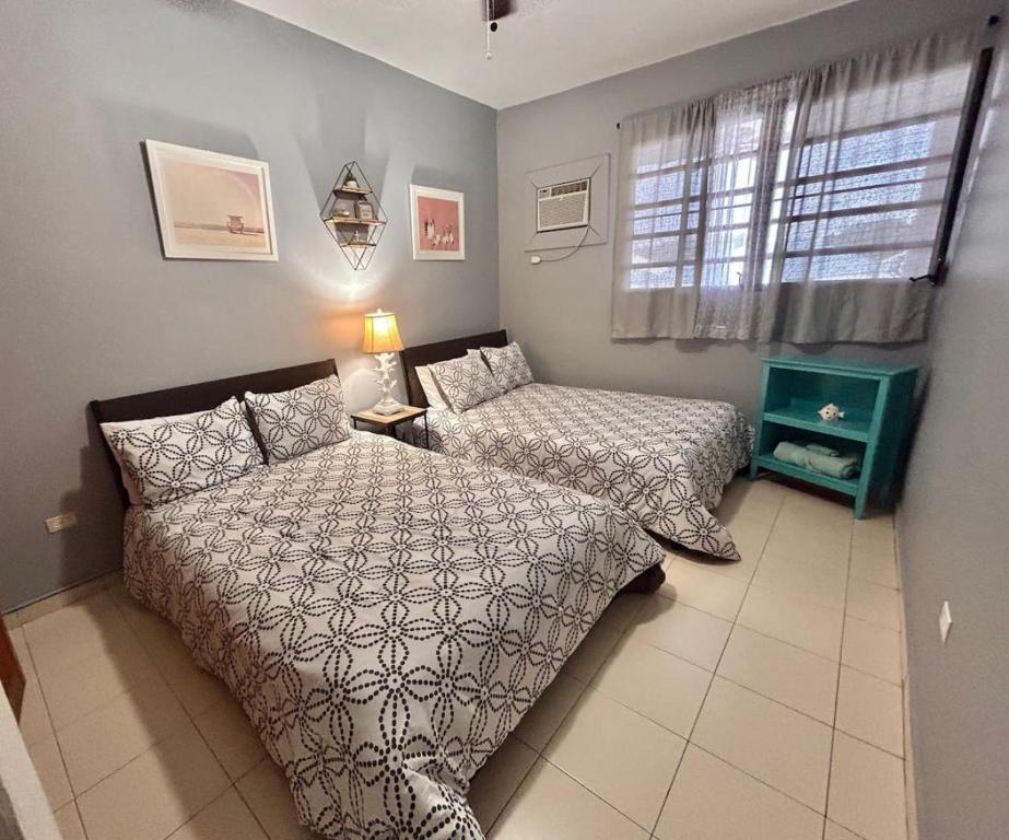 a bedroom with two beds and a window at 2-bedroom Condo in Boqueron in Cabo Rojo