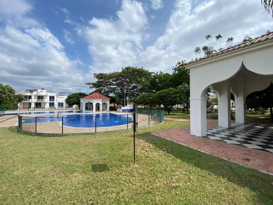 a swimming pool in a yard next to a building at Vacation home in Flandes in Flandes