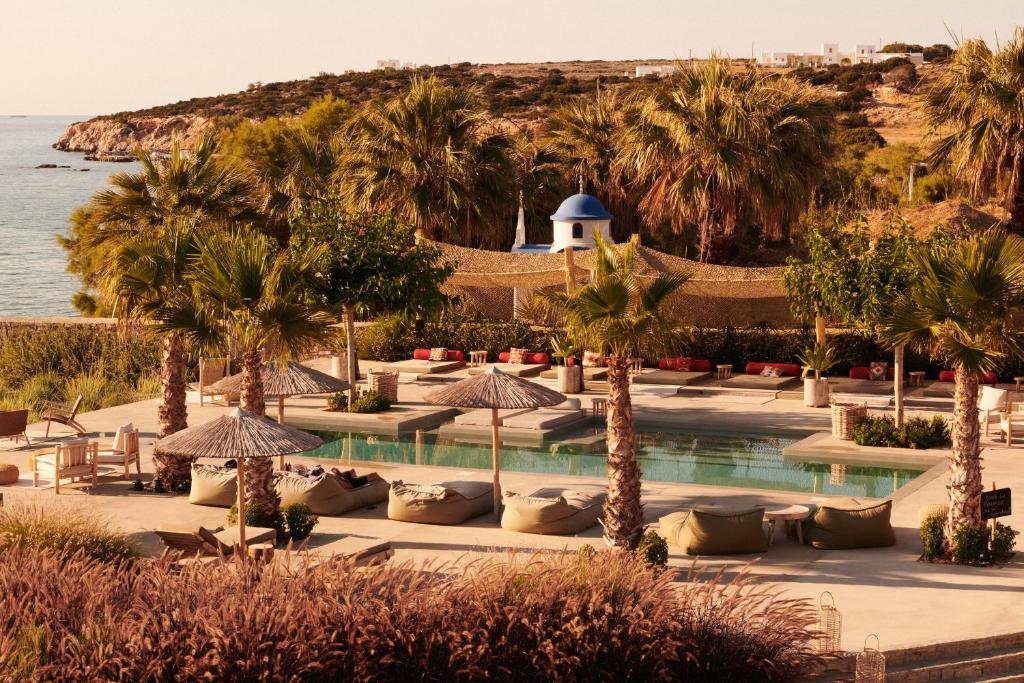 a resort with palm trees and a swimming pool at Seesoo Paros Beachfront Resort in Pounda
