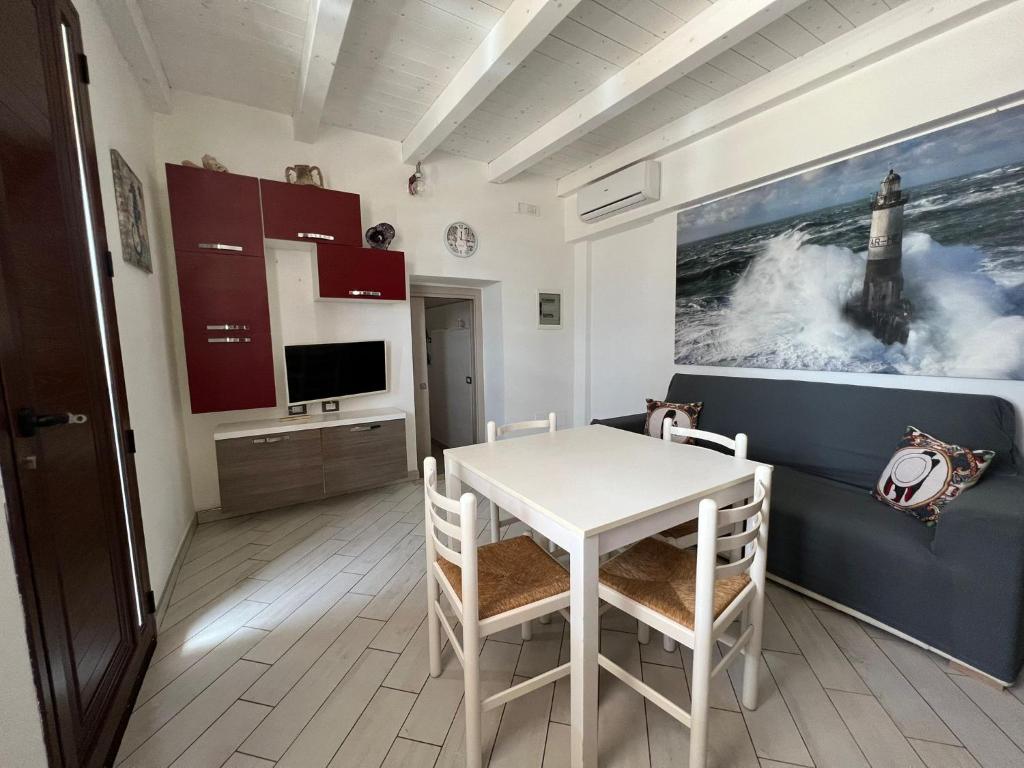 a kitchen with a table and chairs in a room at Mimma house in Lampedusa