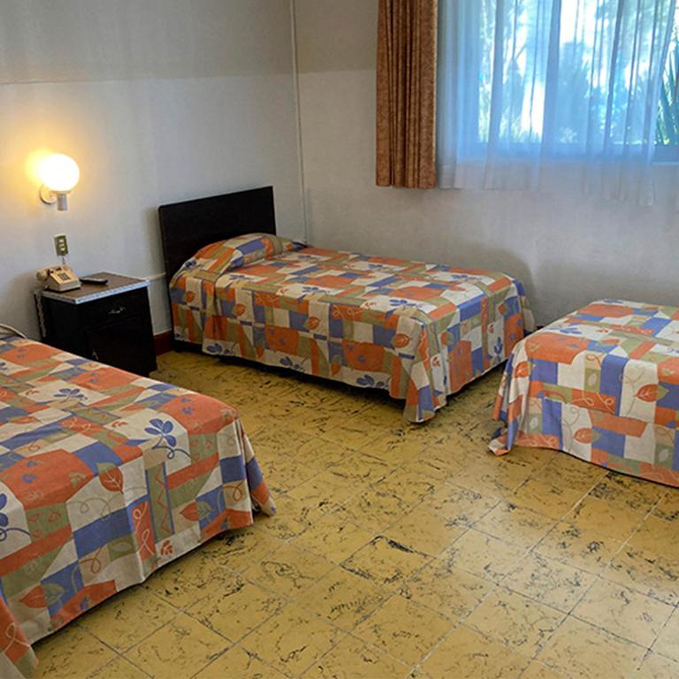 Postel nebo postele na pokoji v ubytování Hotel Y Parque Acuático La Caldera