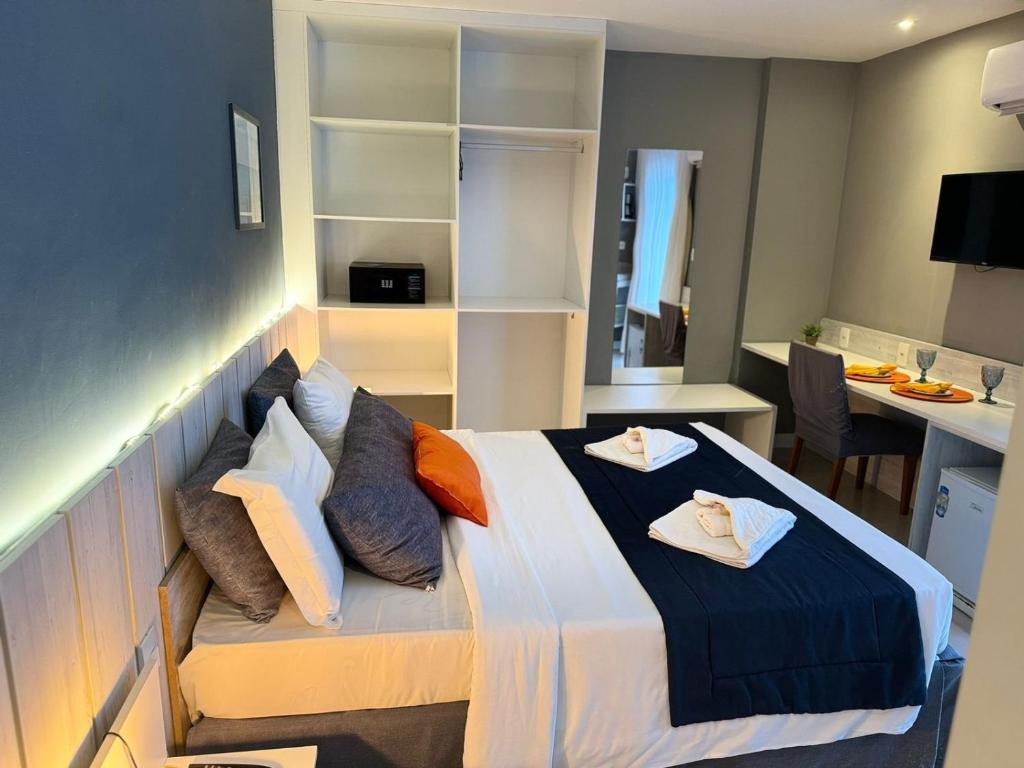 1 dormitorio con 1 cama con 2 toallas en Flat 218 no bairro da Passagem em Cabo Frio, en Cabo Frío
