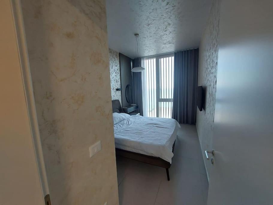 a small bedroom with a bed and a window at Palase Four C apartment 243-E GC in Palasë