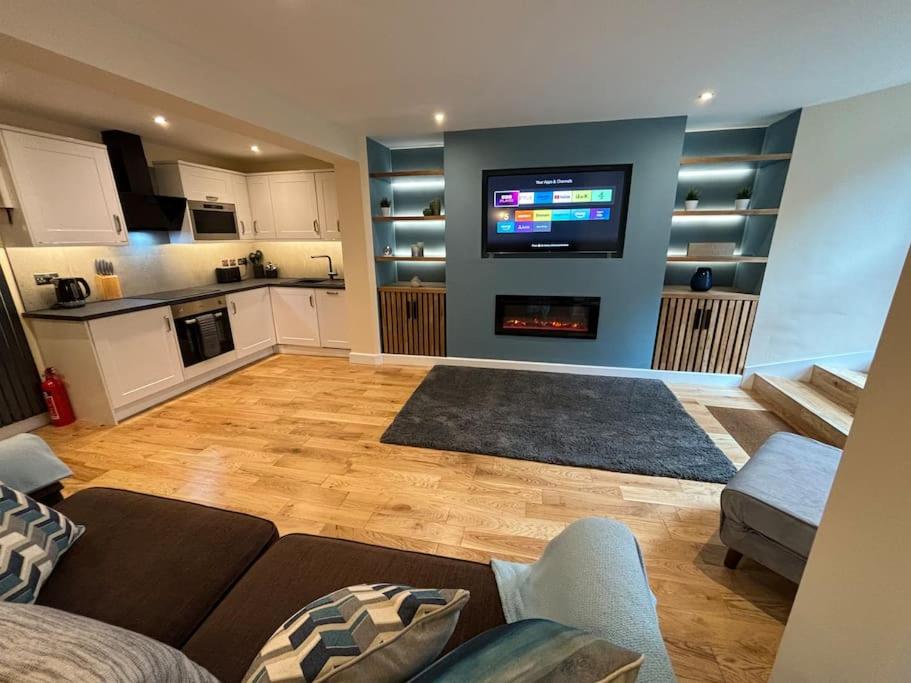 a living room with a couch and a flat screen tv at Minster Bells Suite in York