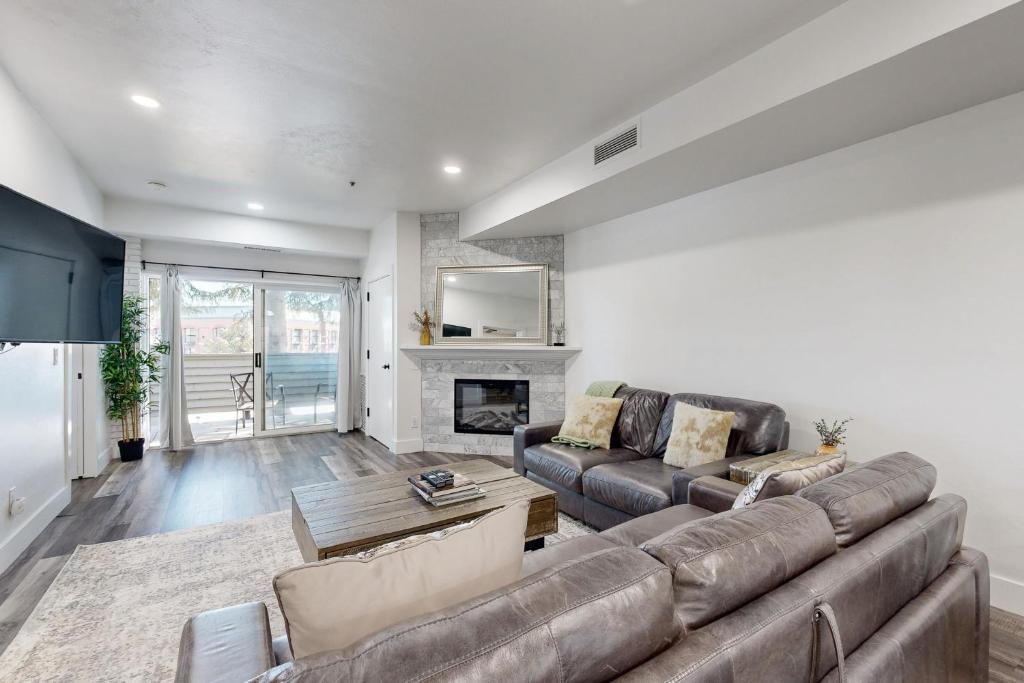 a living room with a couch and a fireplace at Mountainside Charm in Park City