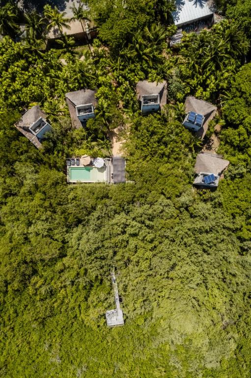 an overhead view of a yard with houses and grass at Vida Silvestre Tulum in Tulum