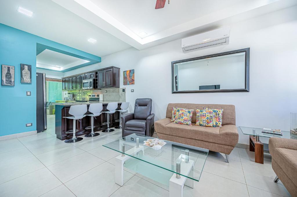 a living room with a couch and a glass table at Jacarandas 4 in Tamarindo