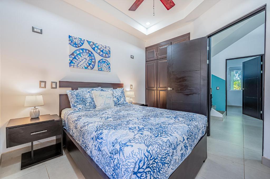 a bedroom with a bed and a glass door at Jacarandas 4 in Tamarindo