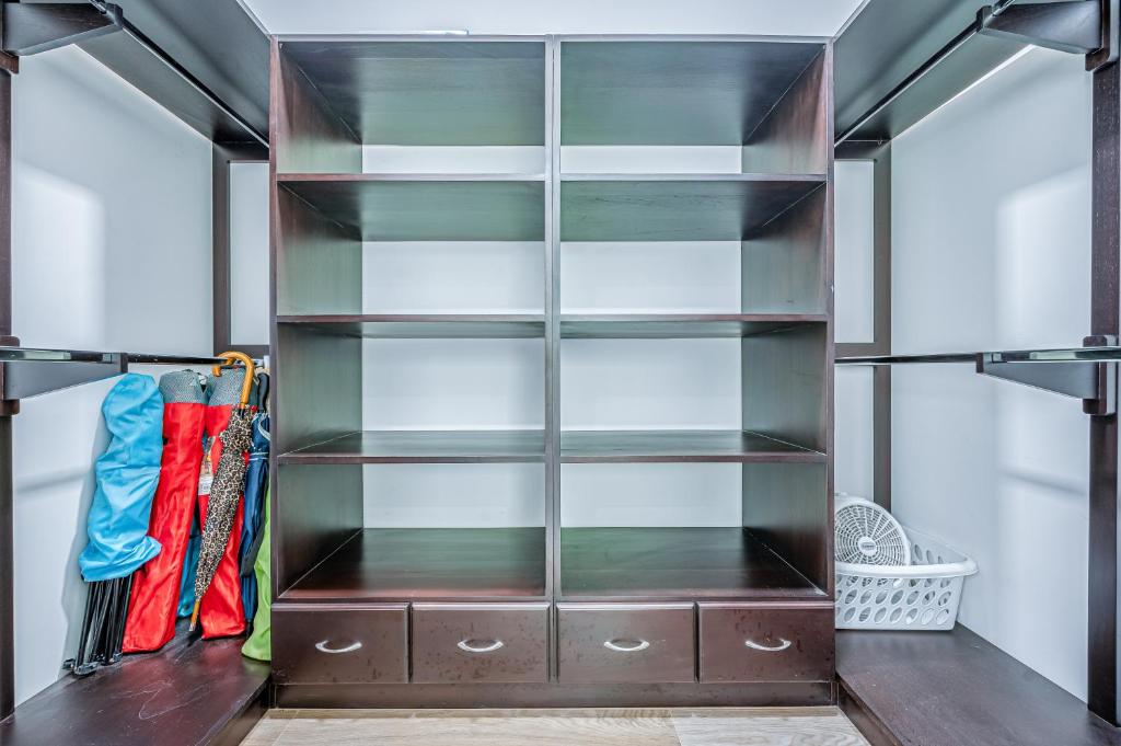 a walk in closet with glass shelves at Jacarandas 4 in Tamarindo