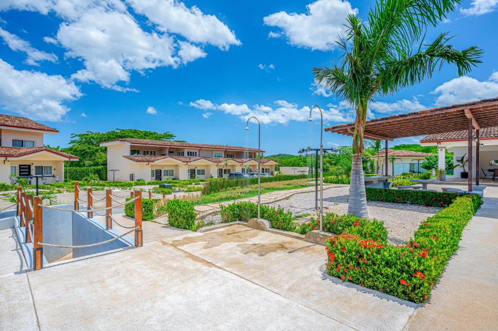a skateboard park with a palm tree and a skateboard ramp at Jacarandas 4 in Tamarindo