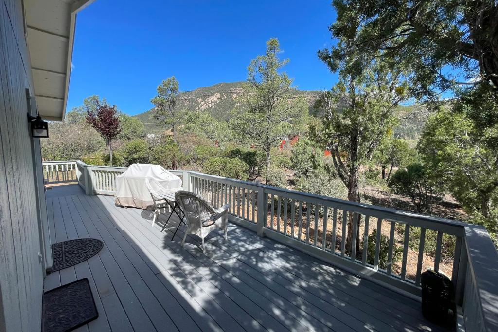 a porch with a table and a bench on it at The Forest Cottage in Payson