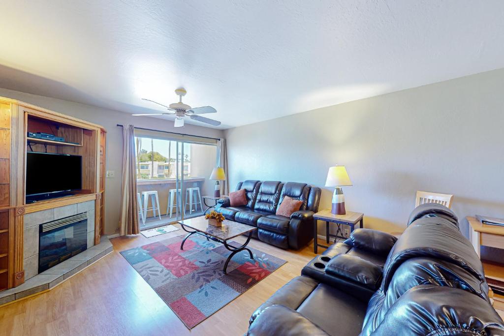 a living room with a couch and a television at Cozy Hideout in Scottsdale