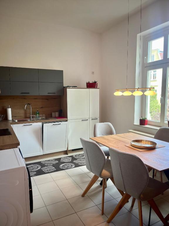a kitchen with a table and chairs in a kitchen at Ferienwohnung Martin Hoop in Bautzen