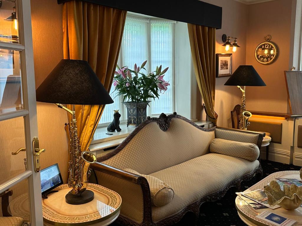 Una sala de estar con un sofá y una ventana. en Chester House Guest House, en Chester