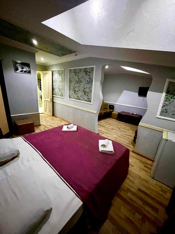 a bedroom with a large bed with two napkins on it at B&B Europa Hotel in Kutaisi