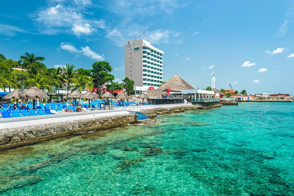 
a large body of water with a large group of people at El Cid La Ceiba Beach in Cozumel
