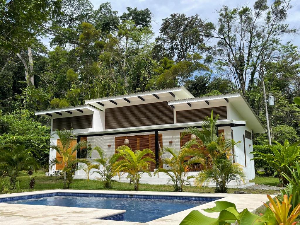 a house with a swimming pool in front of it at Tres Lodge- Private Pool - Nature and Comfort for Groups in Cocles