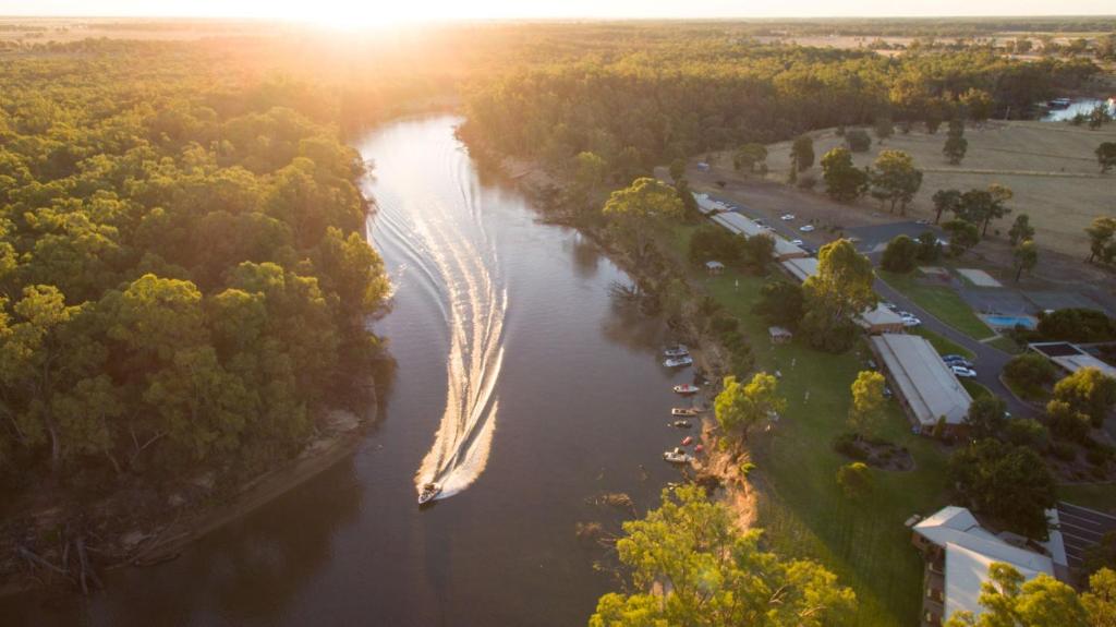 an aerial view of a river with a boat in it at Cadell On The Murray Motel in Moama