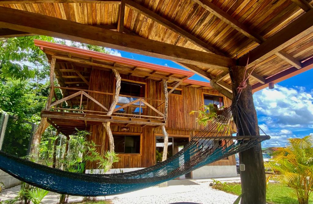 a resort with a hammock in front of it at Cabañas Litos #1 in Fortuna