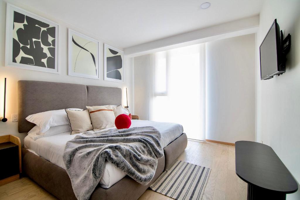 una camera da letto con un letto con una coperta sopra di SANTA FE Red Beautiful Apartment! a Città del Messico