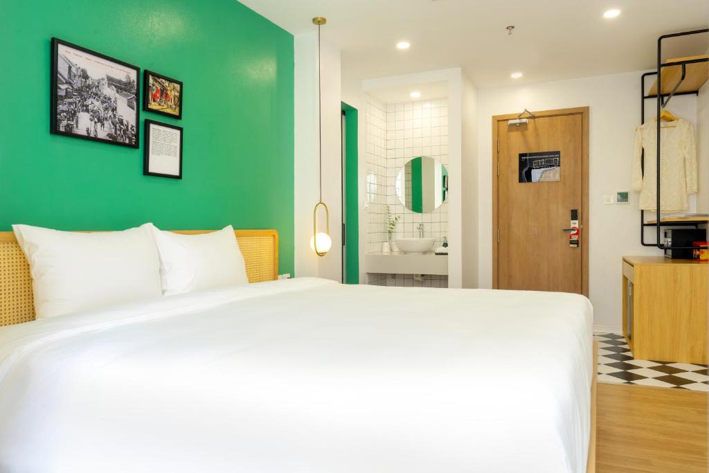 Postel nebo postele na pokoji v ubytování Wilque Hotel Hanoi