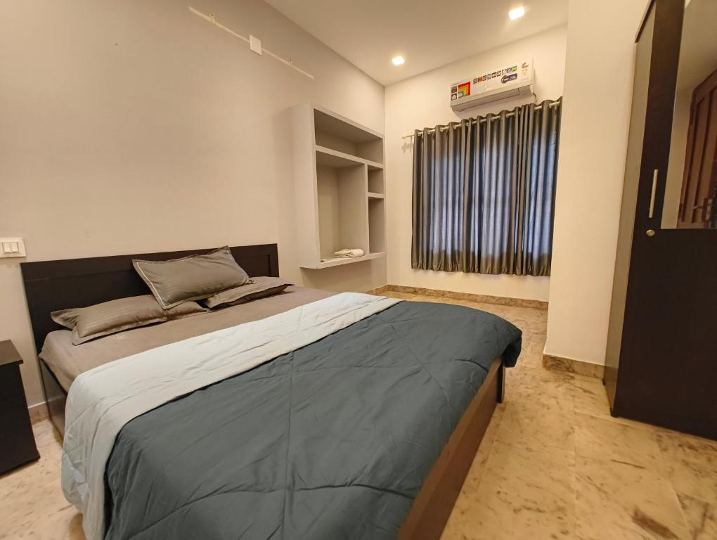 a bedroom with a large bed and a window at Comfort INN in Payyannūr