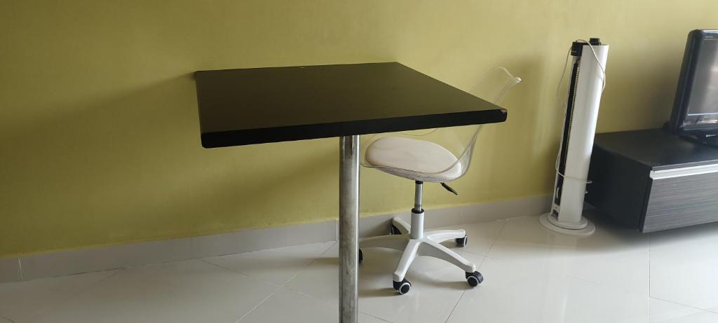 a black desk with a white chair under it at 1 Bedroom Furnished Condo Park Lane 812 in Jomtien Beach