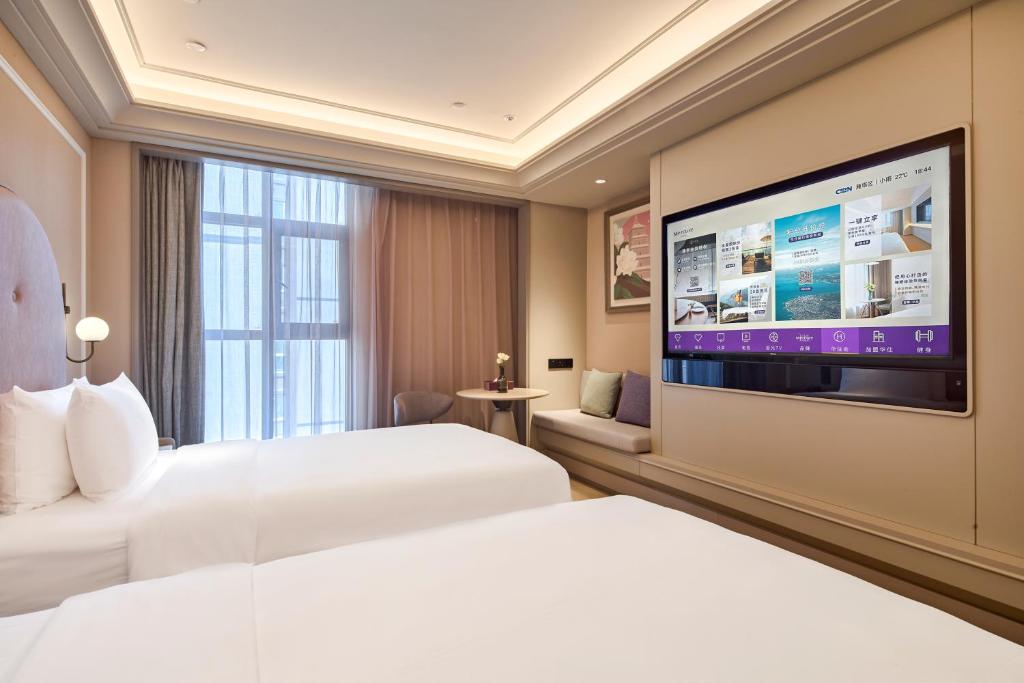 Postel nebo postele na pokoji v ubytování Mercure Xian Dazhai Road