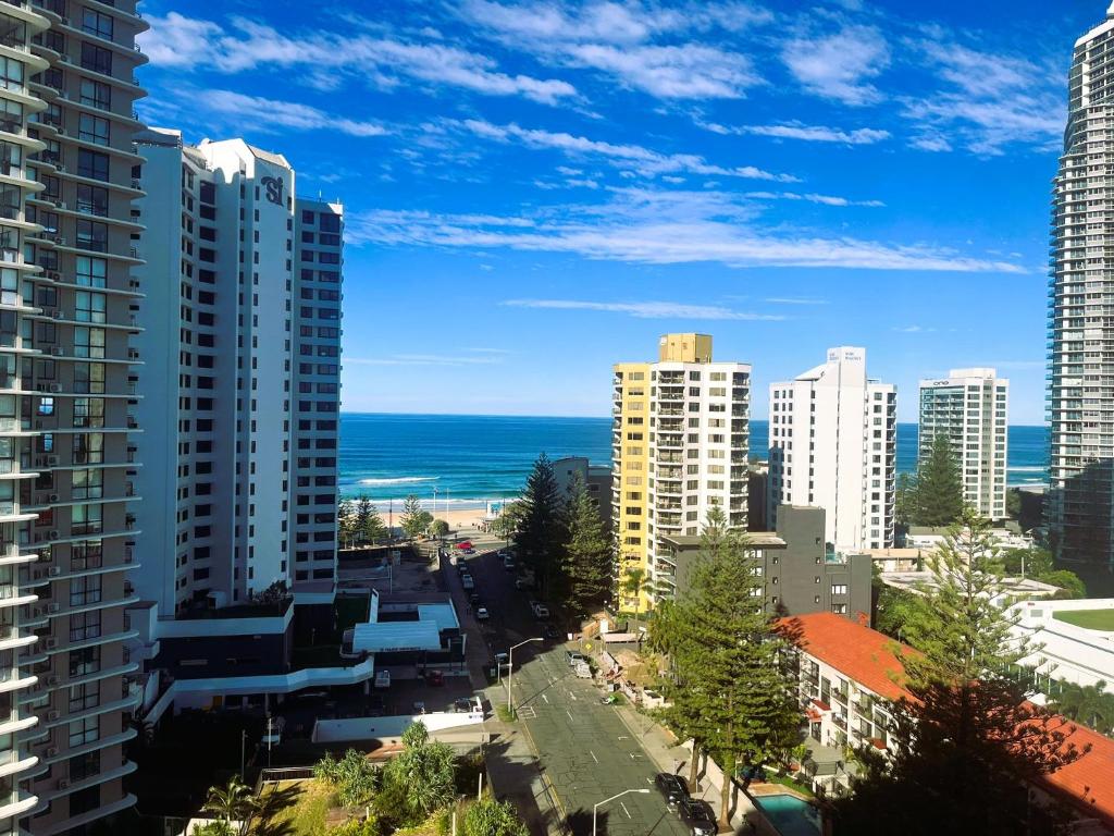 a view of a city with buildings and the ocean at Surfers Private Apartments in Gold Coast