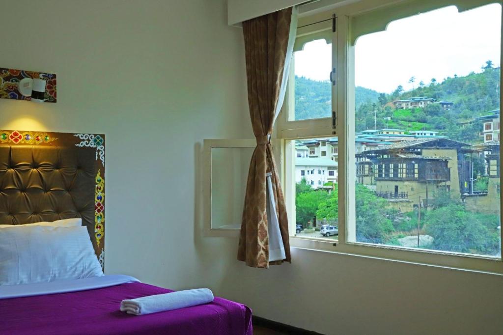 Postel nebo postele na pokoji v ubytování Hotel Bhutan Kubera