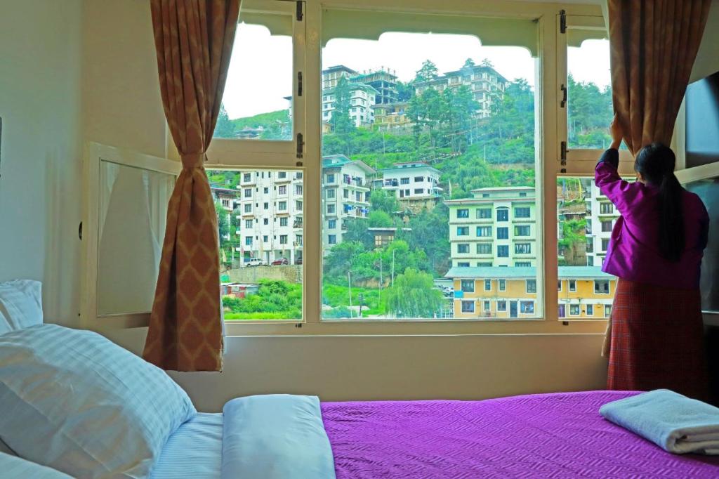 Postel nebo postele na pokoji v ubytování Hotel Bhutan Kubera