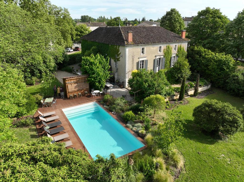 an aerial view of a house with a swimming pool at NAMASTE COTTAGE in Issigeac
