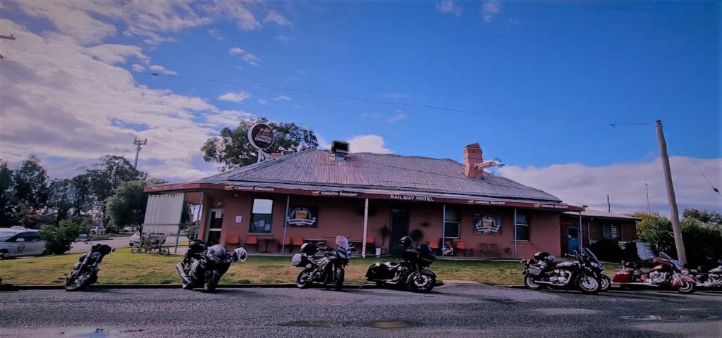 a group of motorcycles parked in front of a building at Lockhart Railway Hotel in Lockhart