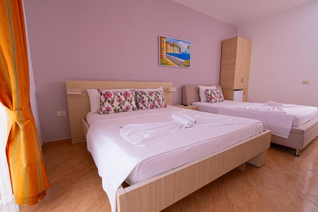 Postel nebo postele na pokoji v ubytování Sun Shine Hotel