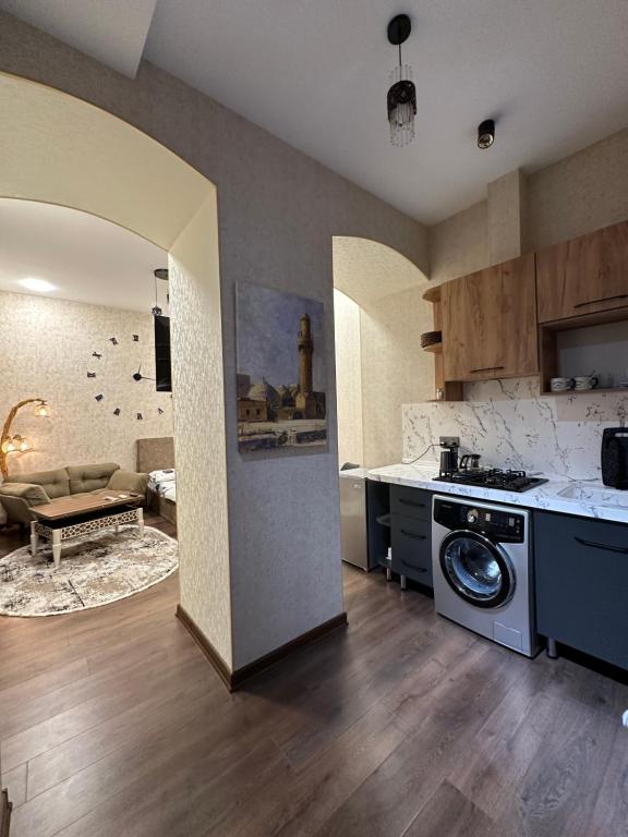 a kitchen with a washing machine in the middle of a room at Lovely flat near the Boulevard Center of Baku in Baku