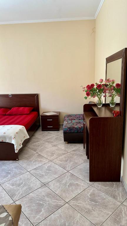 a bedroom with a bed and a desk with a mirror at Stella's House in Eleftheroúpolis