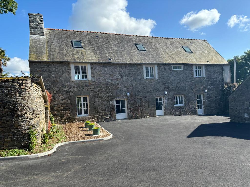 a large stone house with a large driveway at Gites du Manoir de Kergoniou Saint Joseph in Paimpol