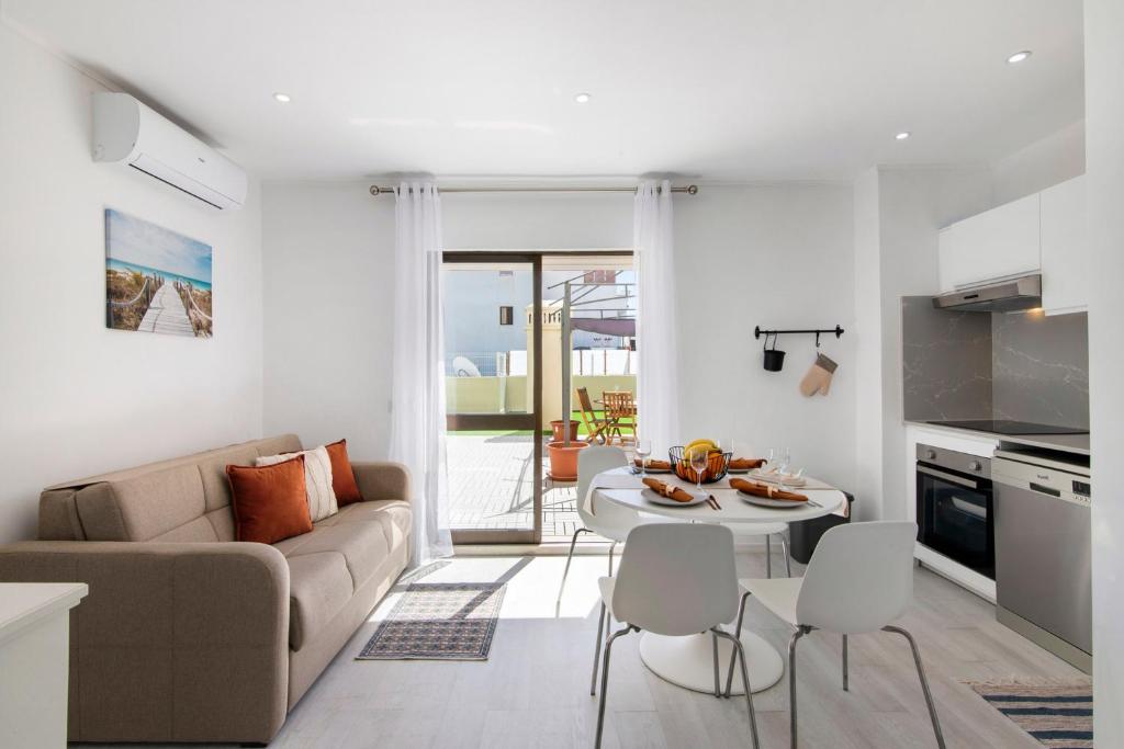a living room with a couch and a table at Penthouse Paradise - Praia da Rocha in Portimão