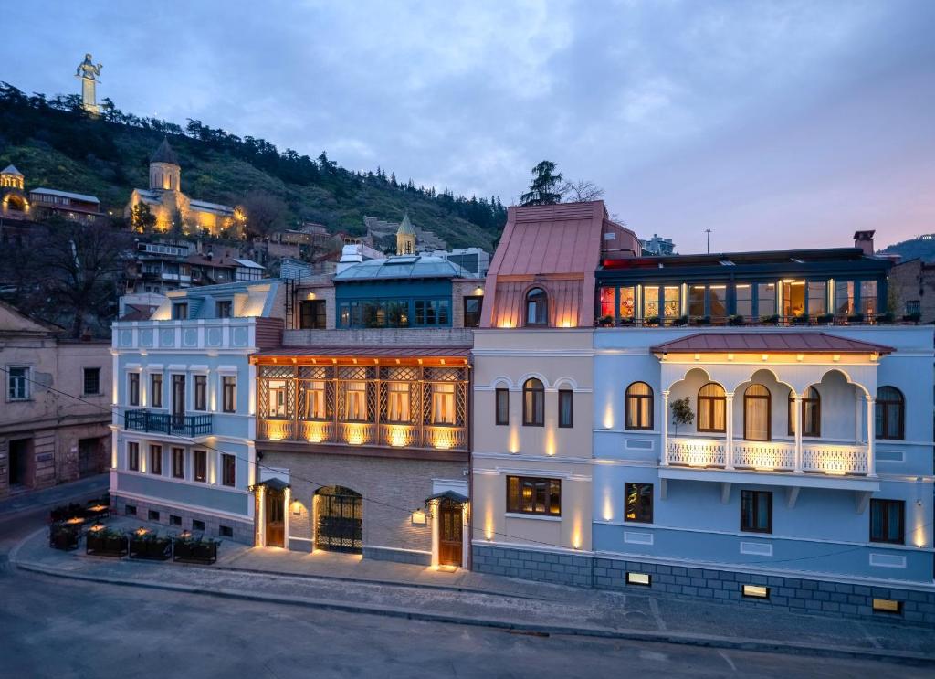a large white building with a lot of windows at Puris Moedani Boutique Hotel in Tbilisi City