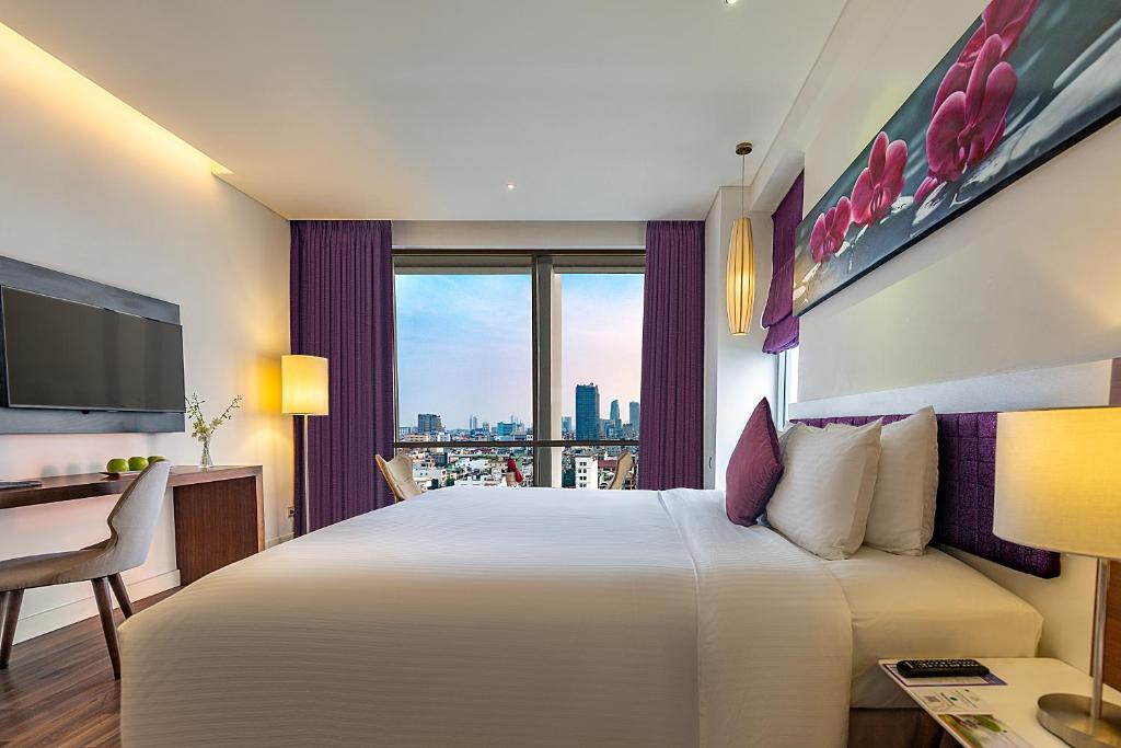 Giường trong phòng chung tại Vanda Hotel